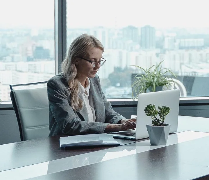 executive female working with Yardi on laptop in office