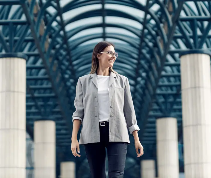 A business woman standing in front of a business center.